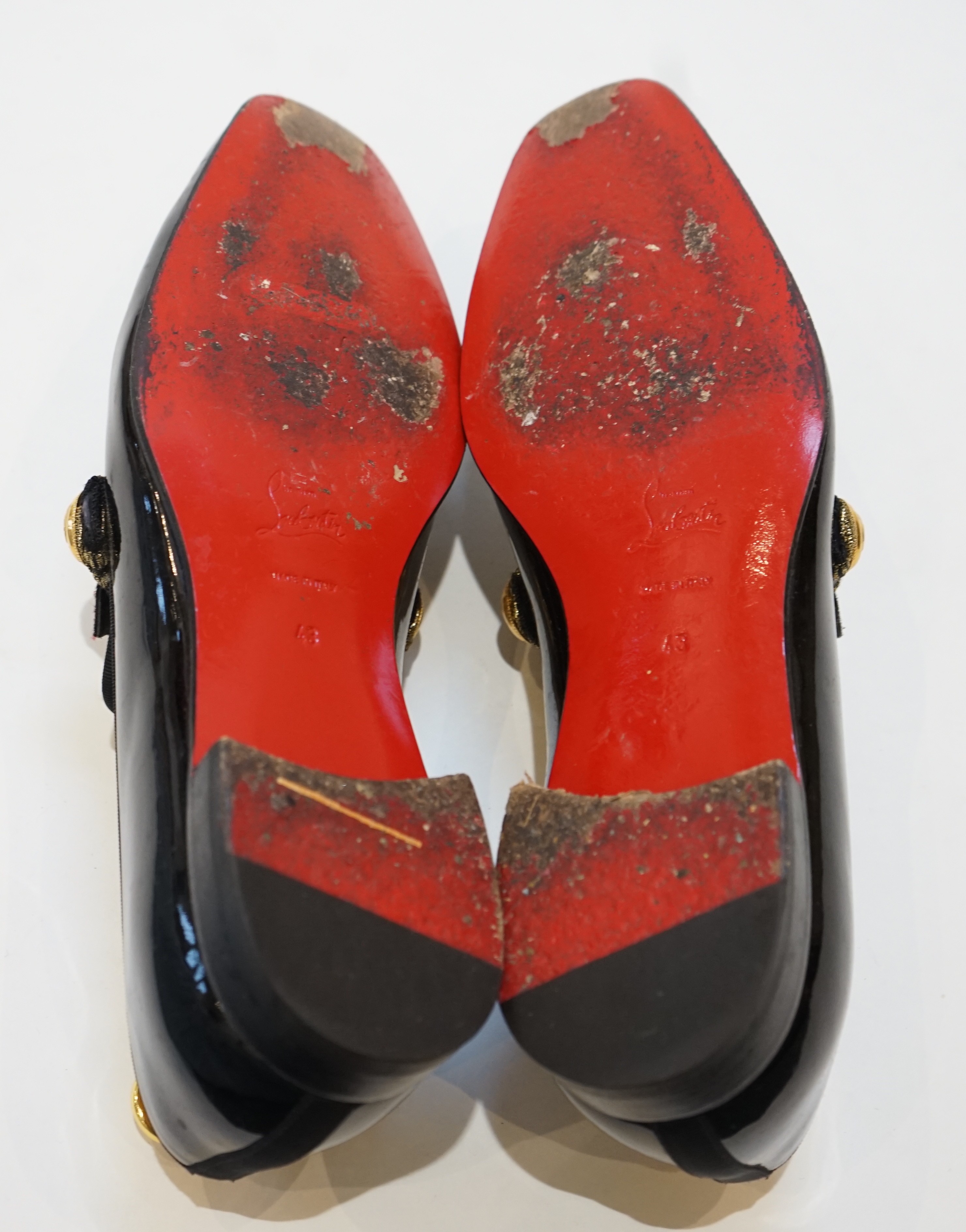 A pair of gentleman's Christian Louboutin patent leather dress shoes with applied and embroidered crests, size 43, in bag